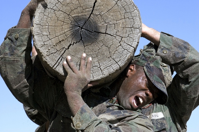 Navy SEALS training with a log